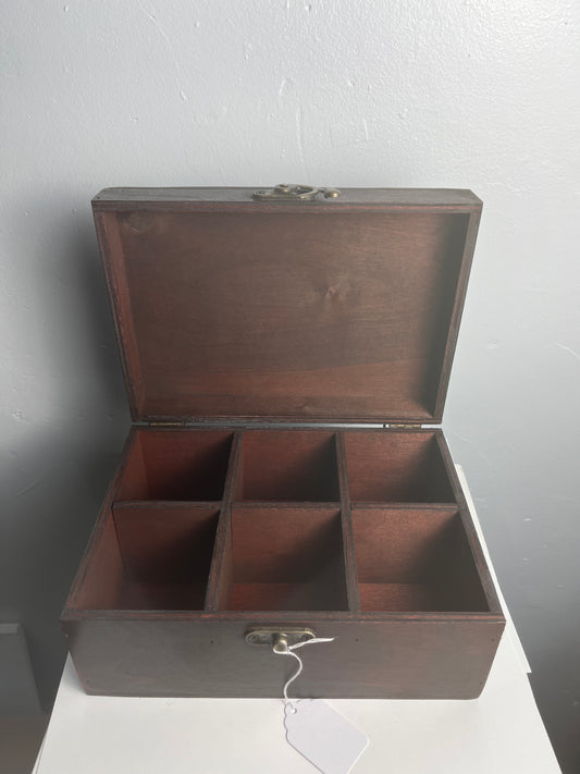 Wooden tea box with open lid on a gray background