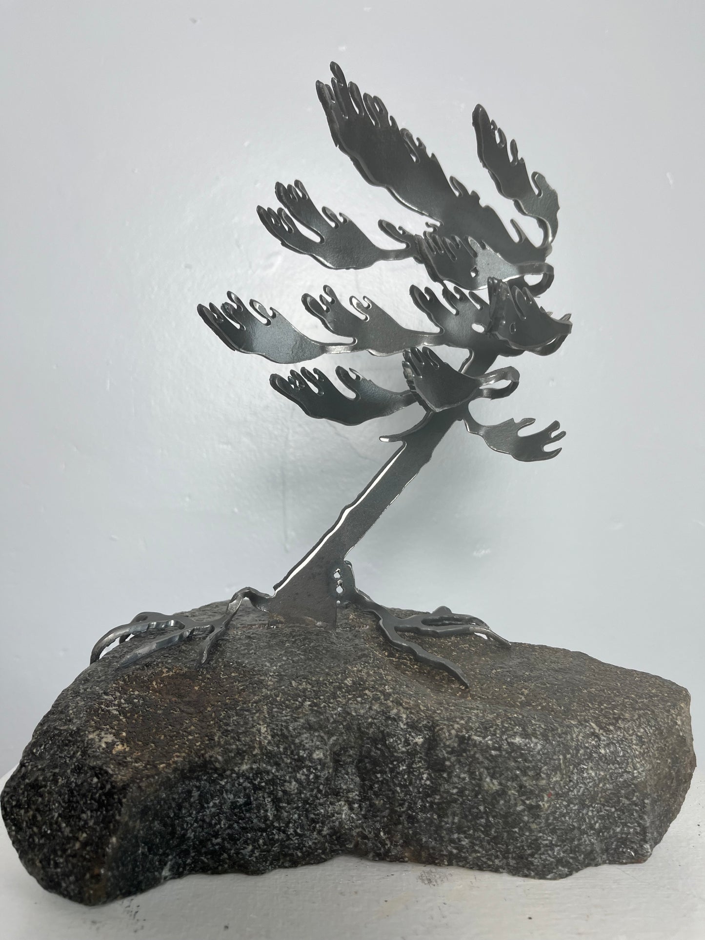 Cathy mark windswept metal tree on stone