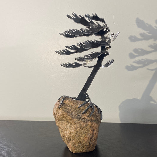Metal windswept tree on granite