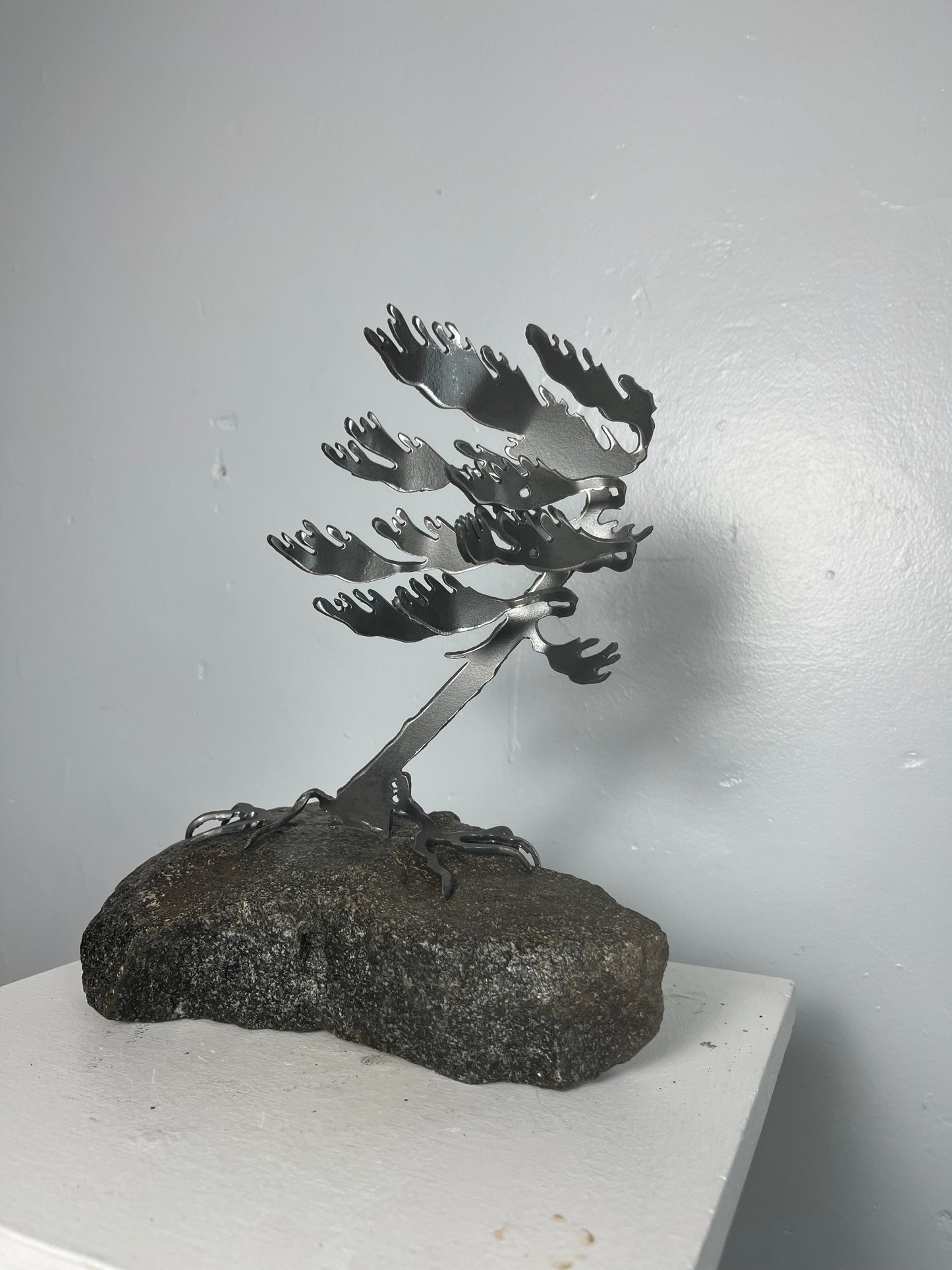 Cathy mark windswept metal tree on stone