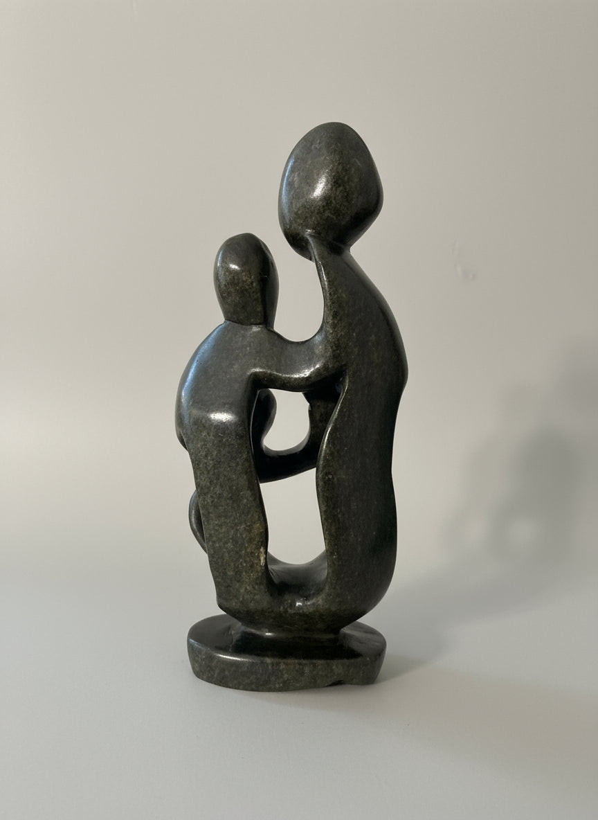 Back view of stone sculpture family of 4
