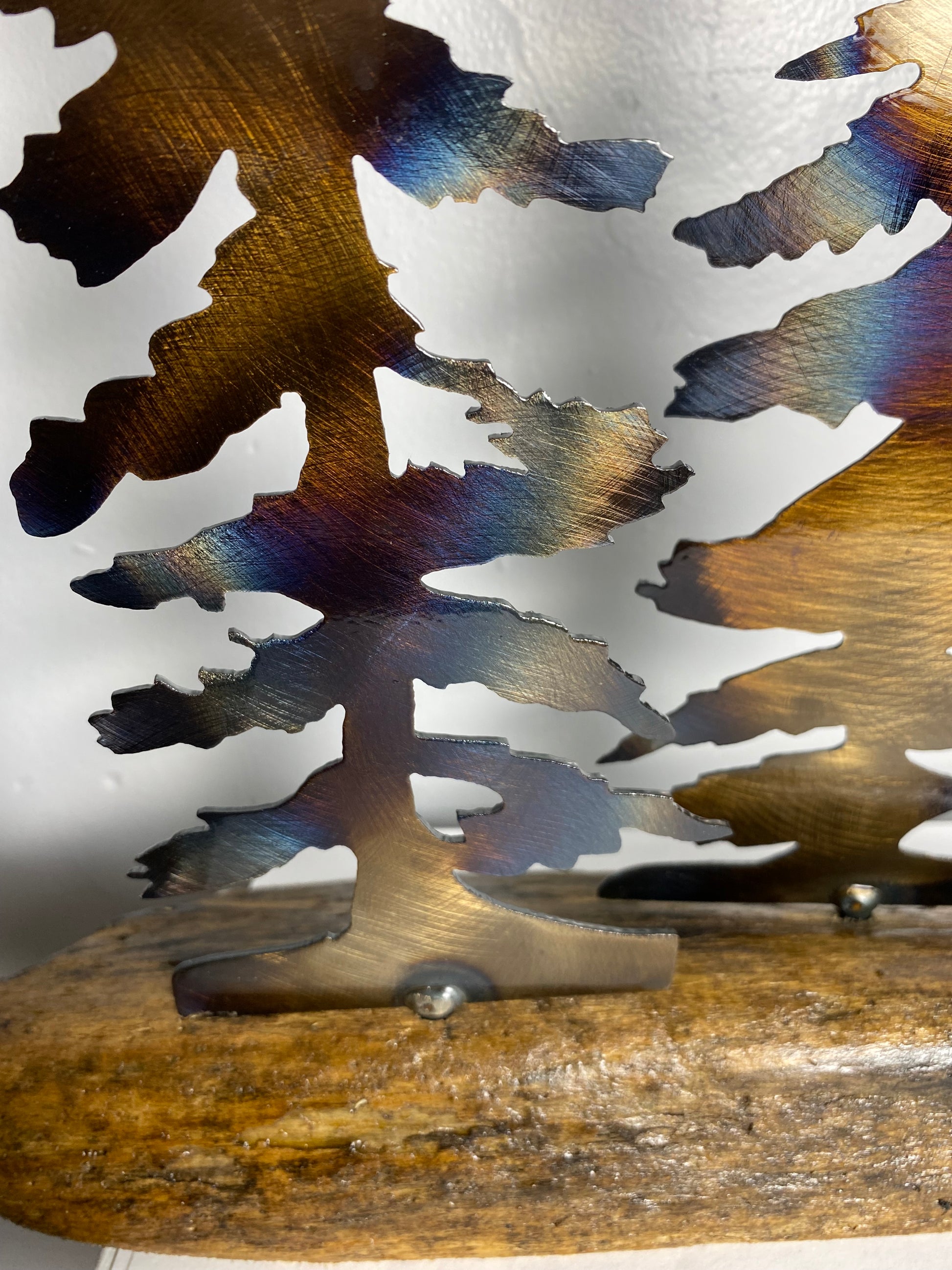 close up of metal trees on a wood base