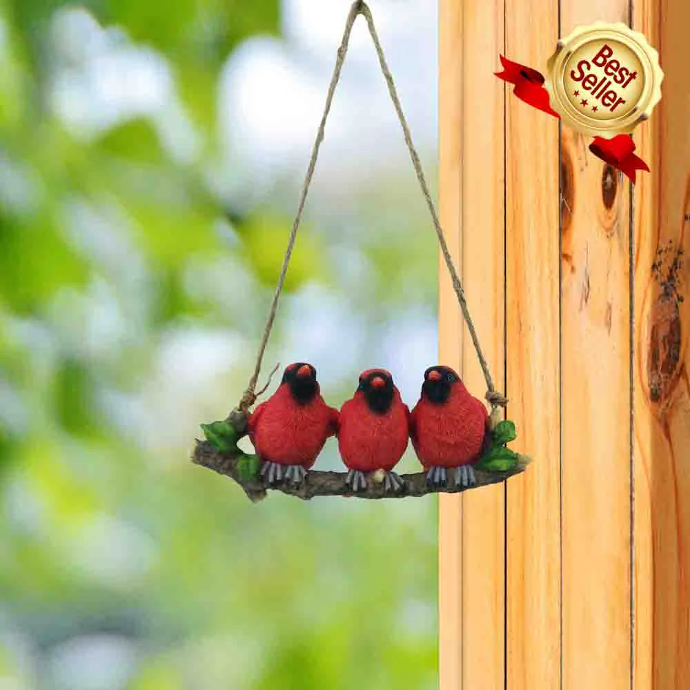 Hanging resin cardinals on a branch