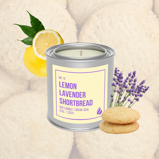 Candle in a tin labeled 'Lemon Lavender Shortbread' with lemon, lavender, and cookies on a soft background