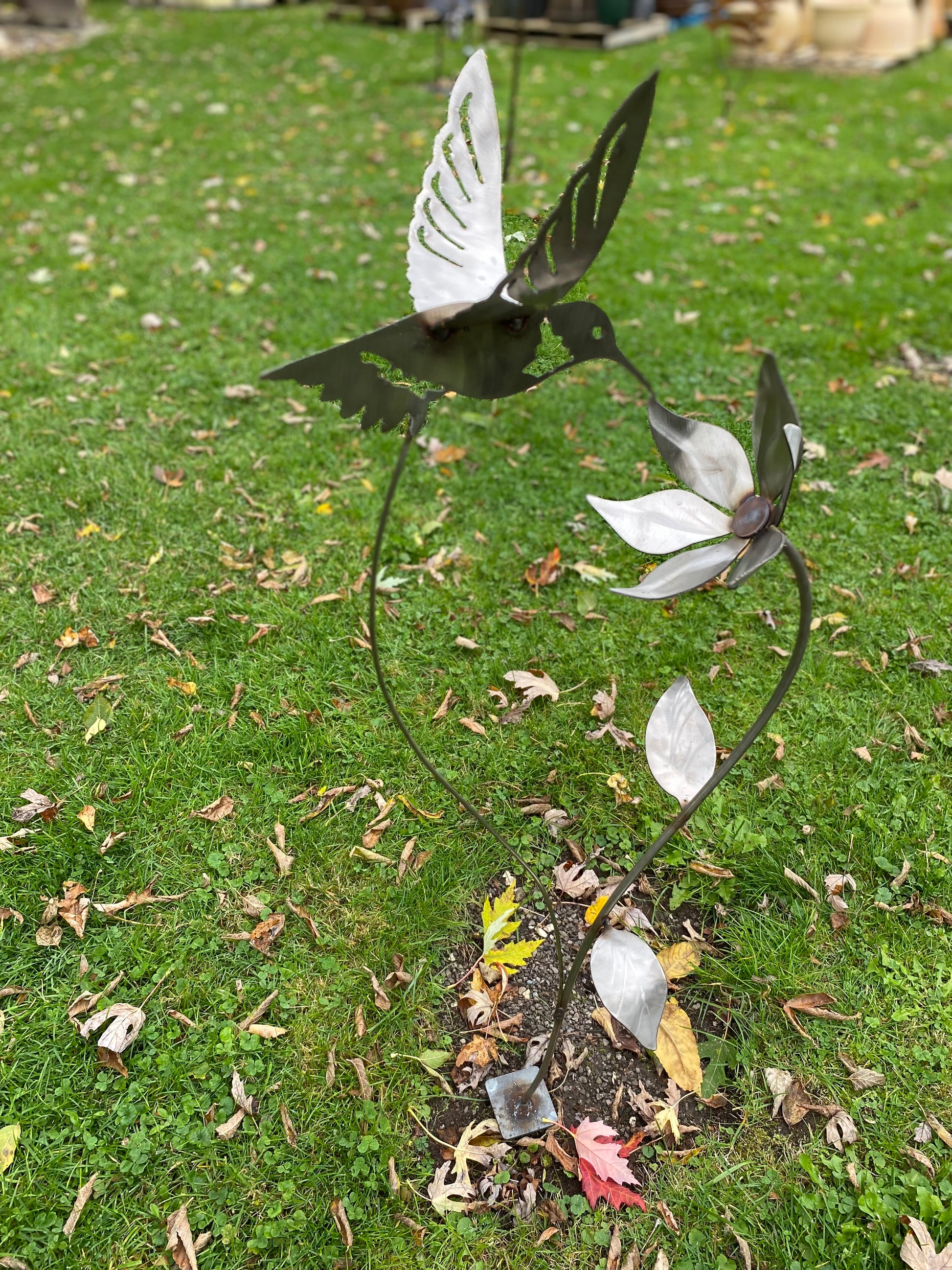 Metal hummingbird and flower garden stake