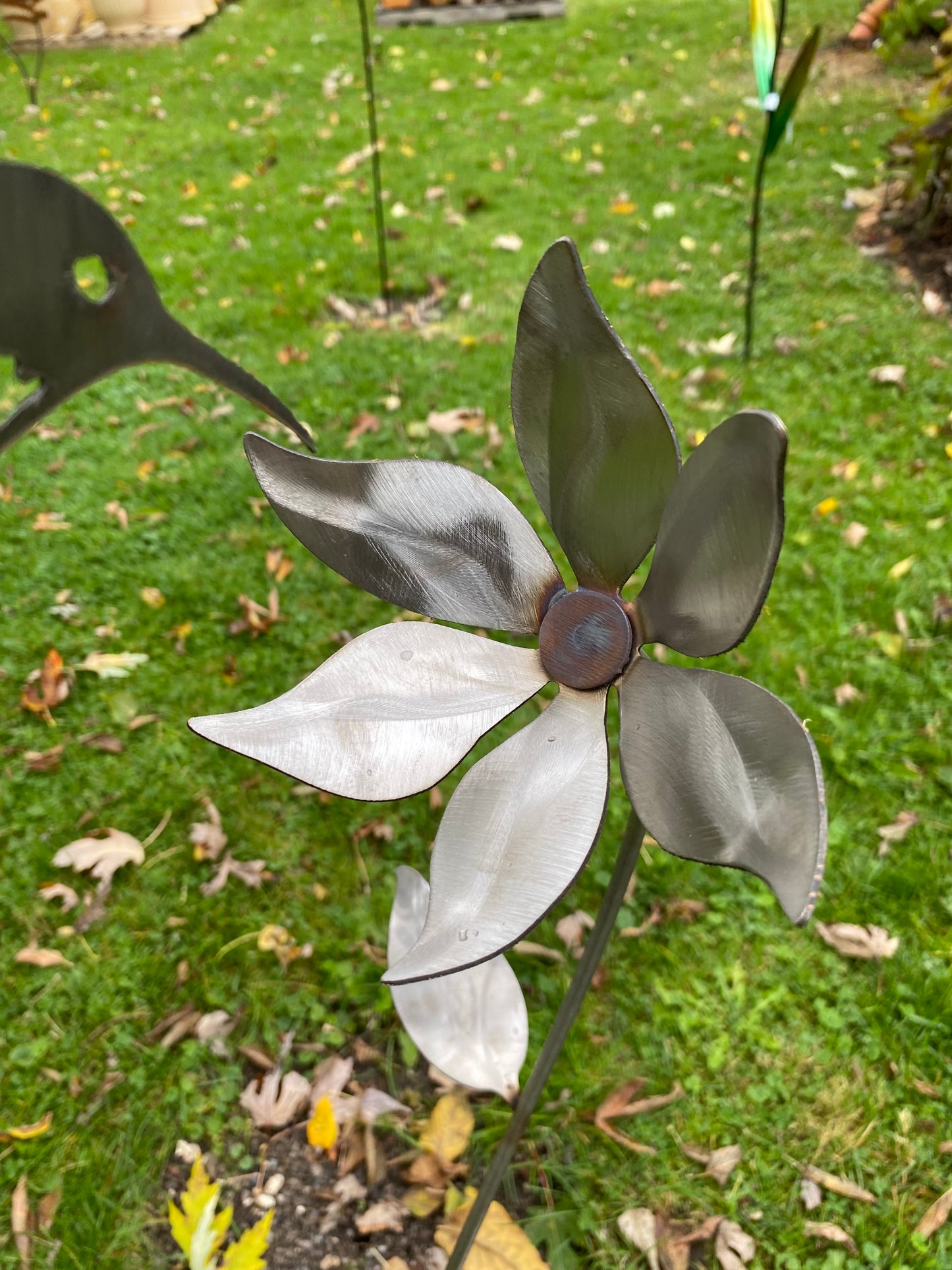 Metal hummingbird and flower garden stake