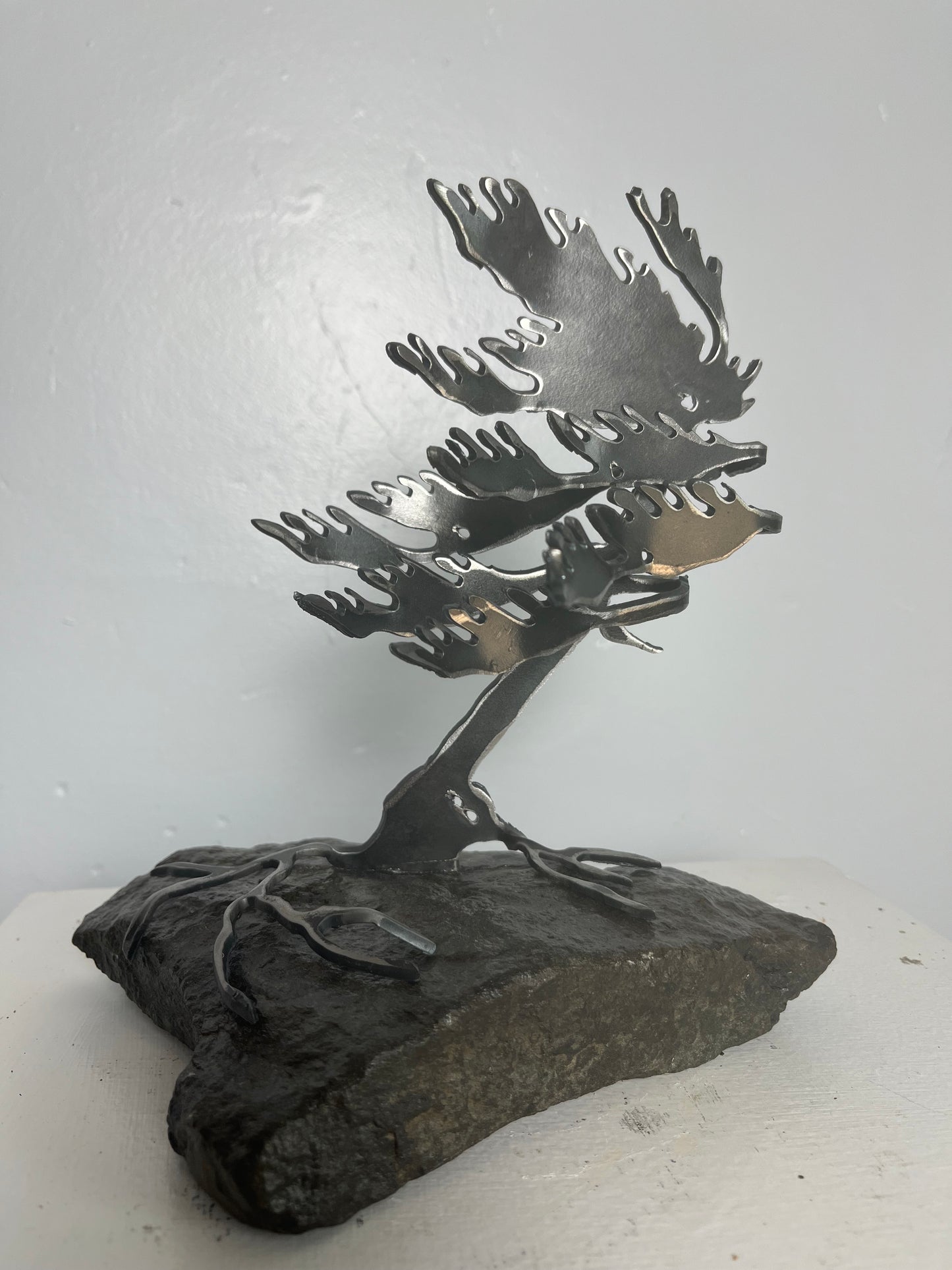 Cathy mark windswept metal tree on stone