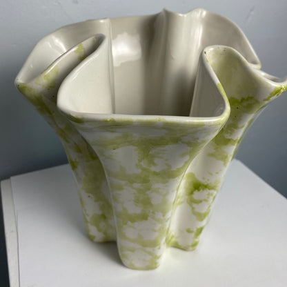 White ceramic vase with green patterns on a white background