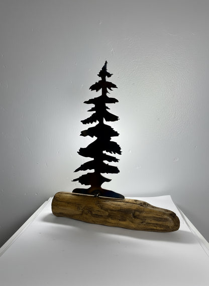 Metal trees on driftwood