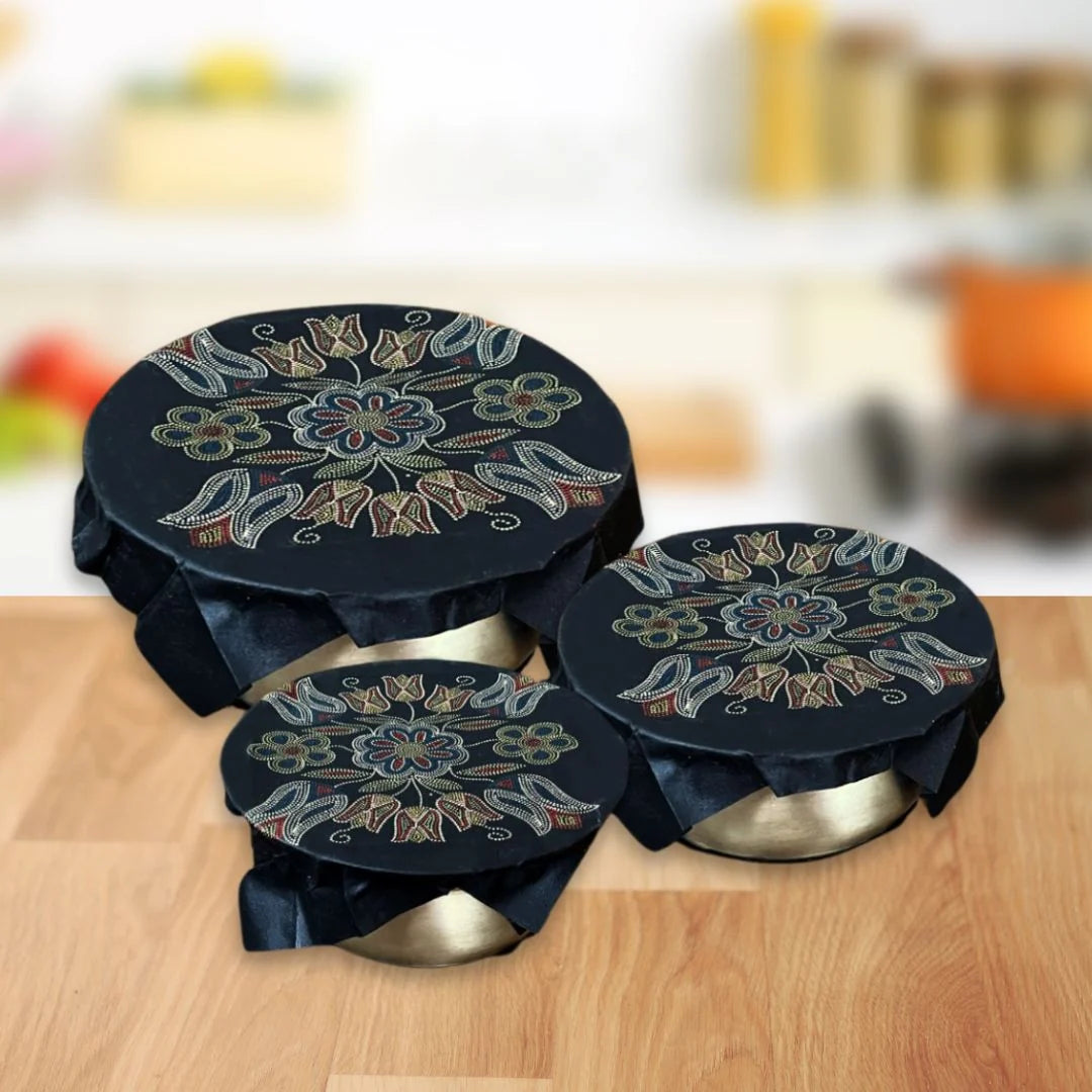 Deb Malcolm's Silver Threads eco food wraps on three bowls, black with a silver floral beadwork design.