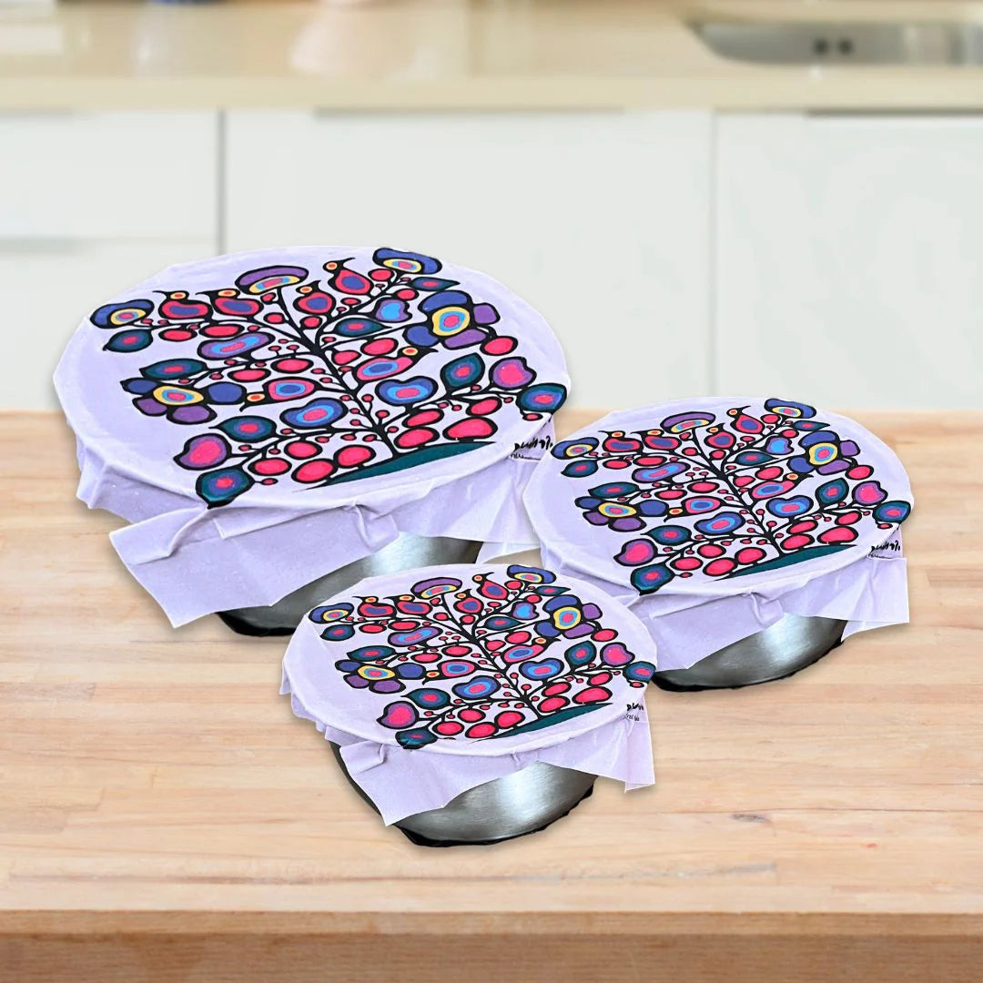 Norval Morrisseau's Woodland Floral eco food wraps on three bowls, with a colourful floral tree print.