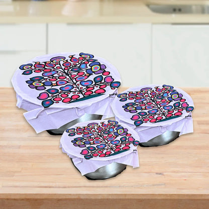 Norval Morrisseau's Woodland Floral eco food wraps on three bowls, with a colourful floral tree print.