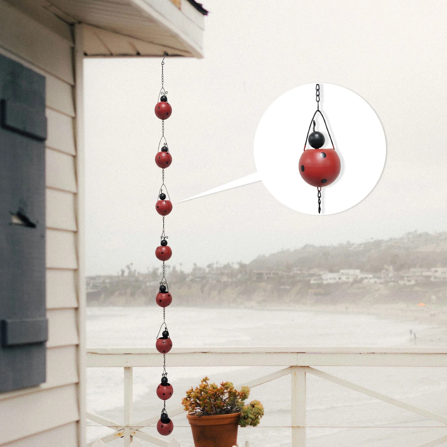 Ladybug Rain Chain hanging from an eaves trough
