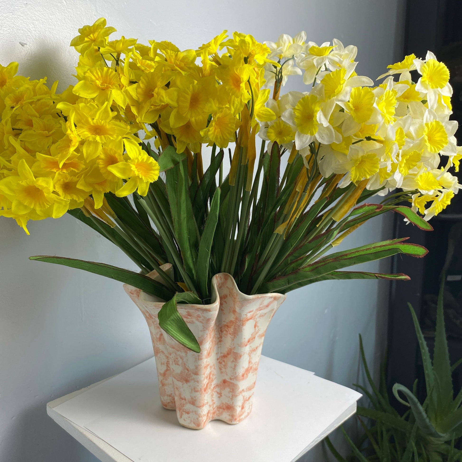 Bouquet of Daffodils in a Peach and White art deco vase