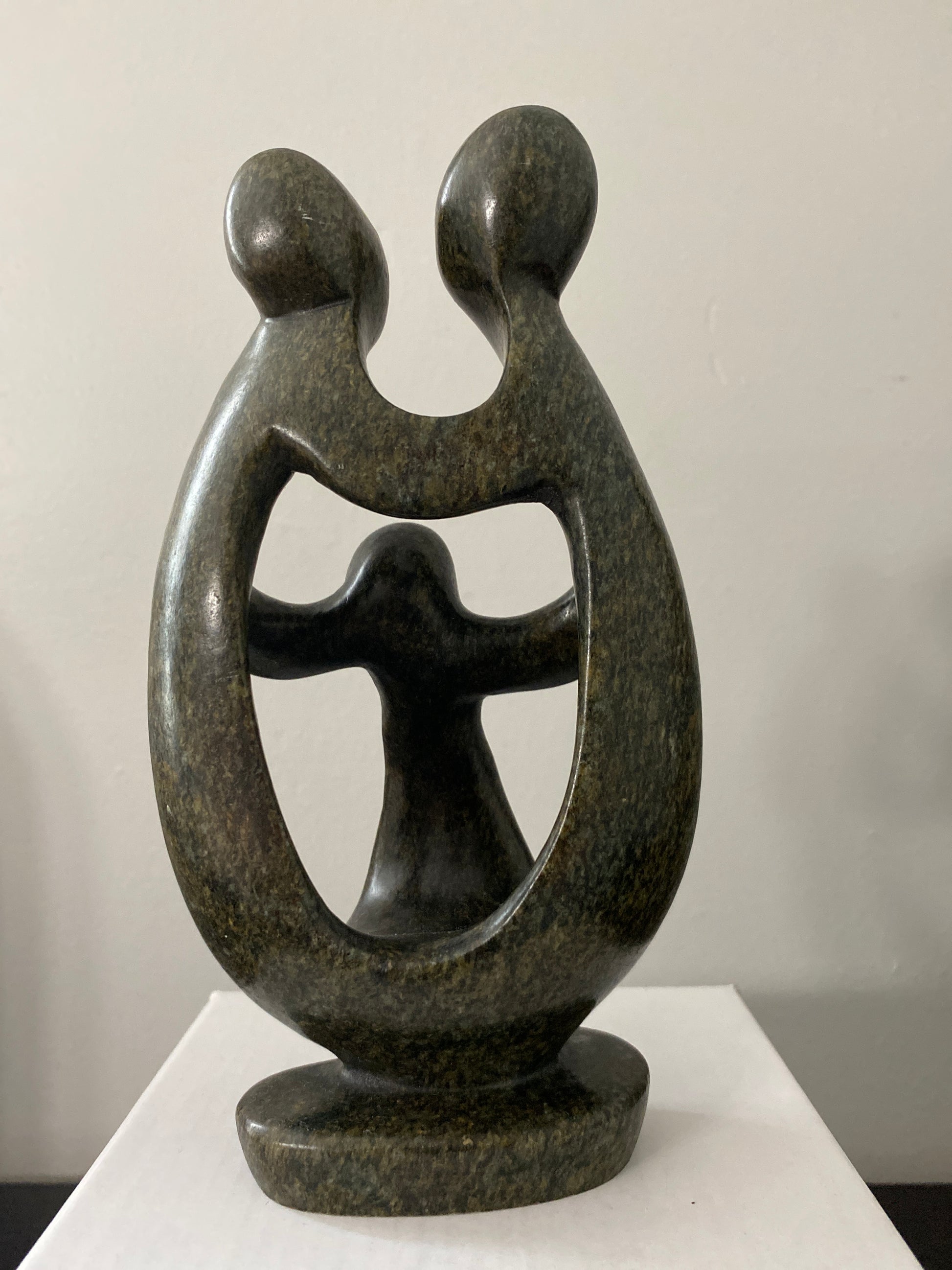 Back view of  shona sculpture family of 3