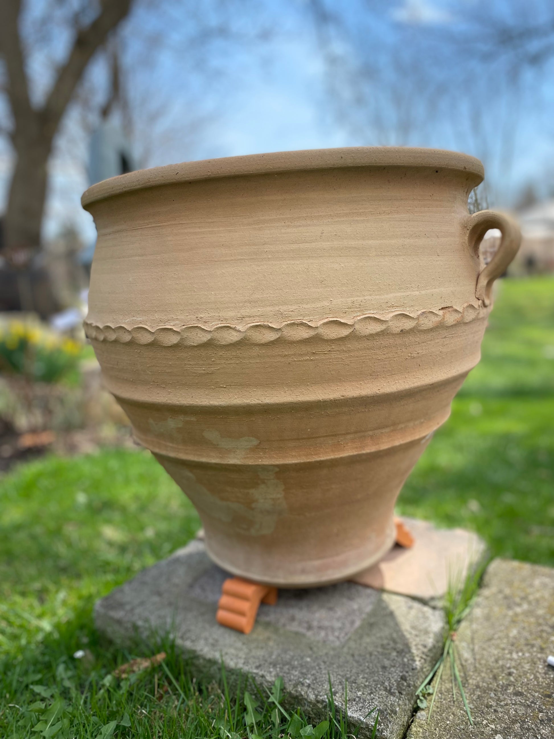 Large terracotta pot with decorative patterns 