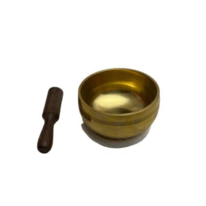 Brass singing bowl with wooden striker on a white background