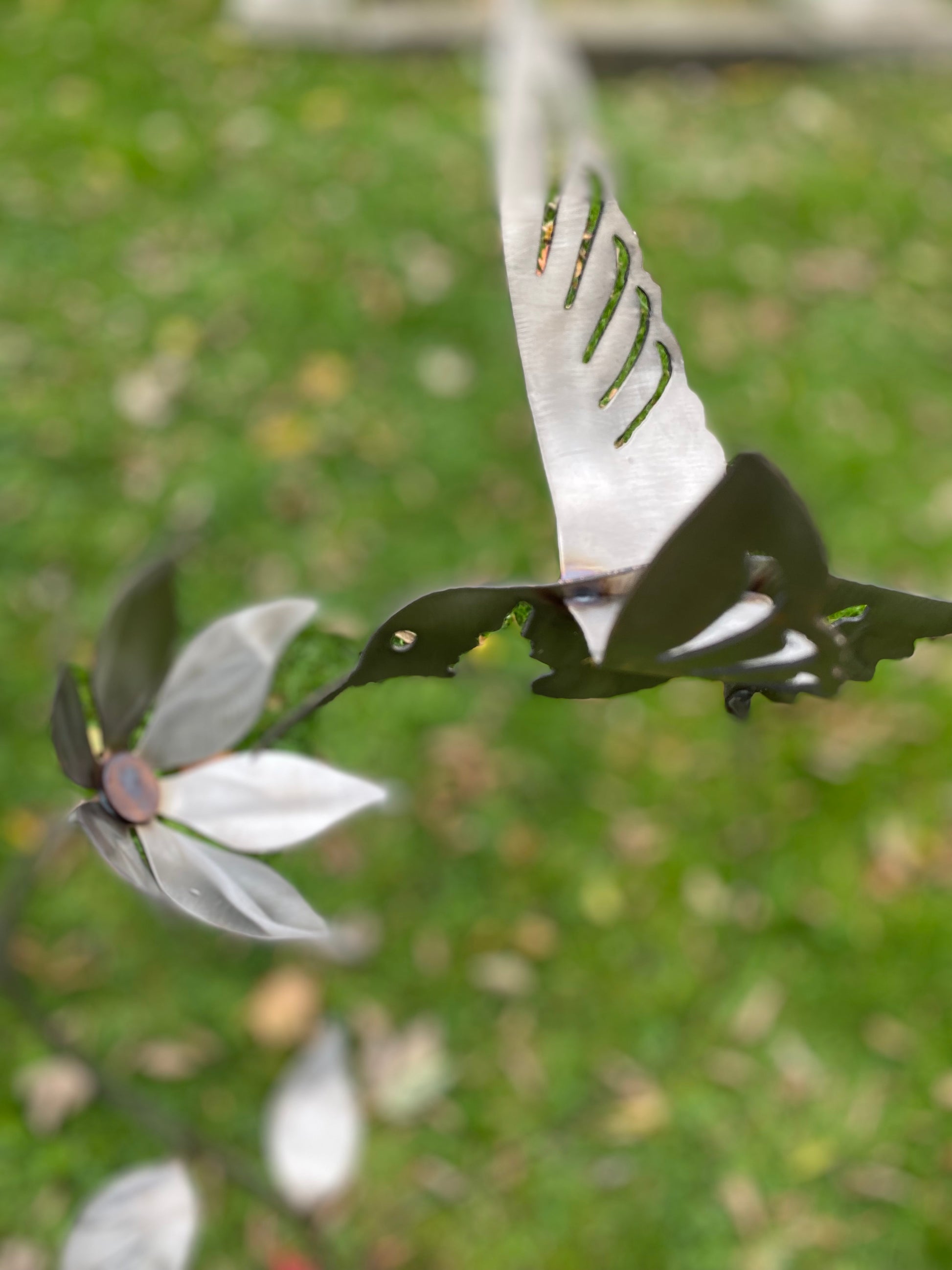 Metal hummingbird and flower garden stake