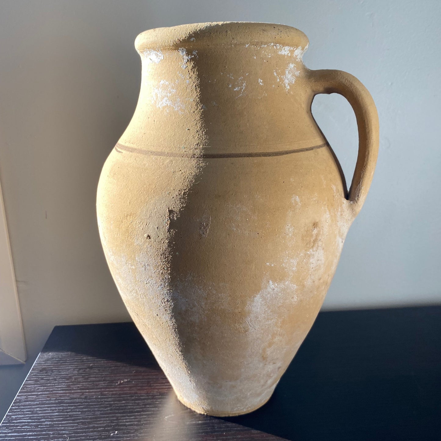 Ancient ceramic vase on a plain background