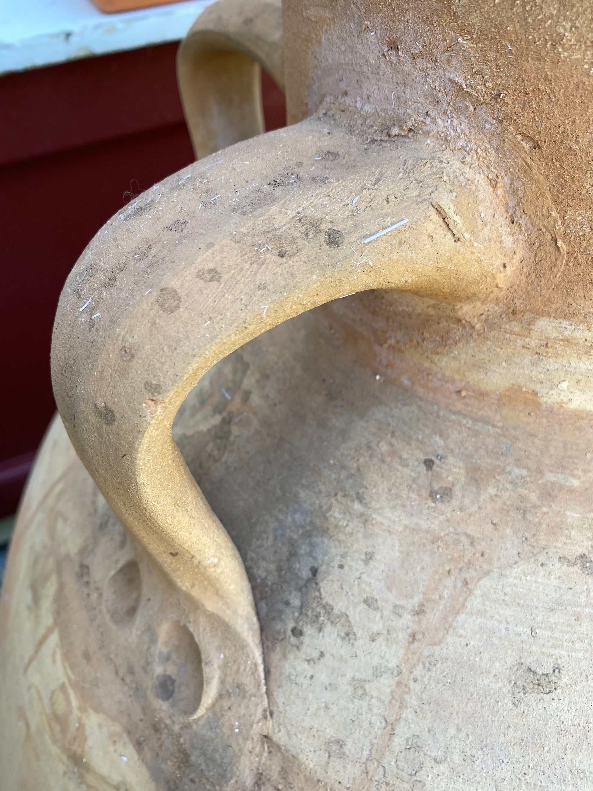 Close-up of handles of decorative pot