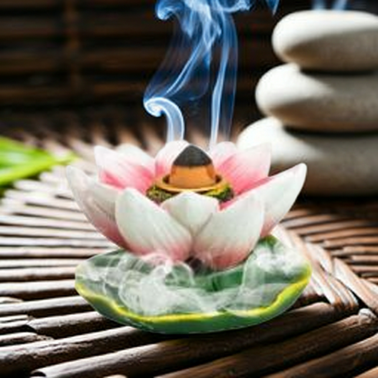 Decorative incense burner shaped like a lotus flower with incense.