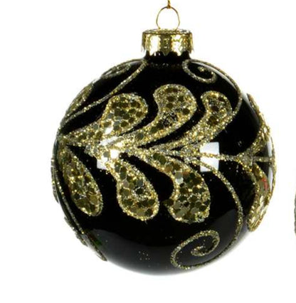 Three black Christmas ornaments with gold decorative patterns