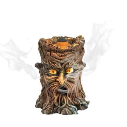 Tree stump incense burner with face design on a white background