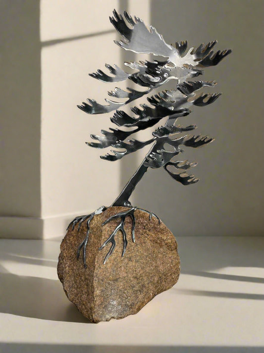 Metal windswept tree on granite