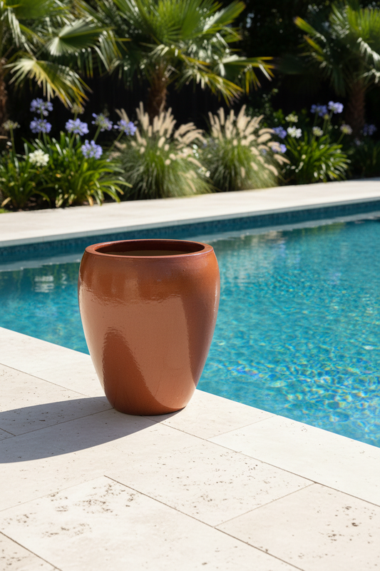 Vietnamese glazed terracotta planter beside a swimming pool