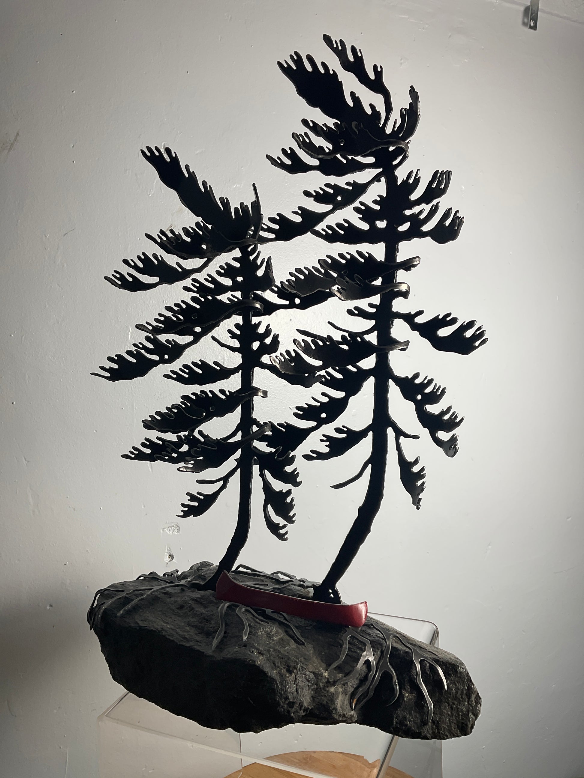 Cathy Mark windswept pines with canoe on granite