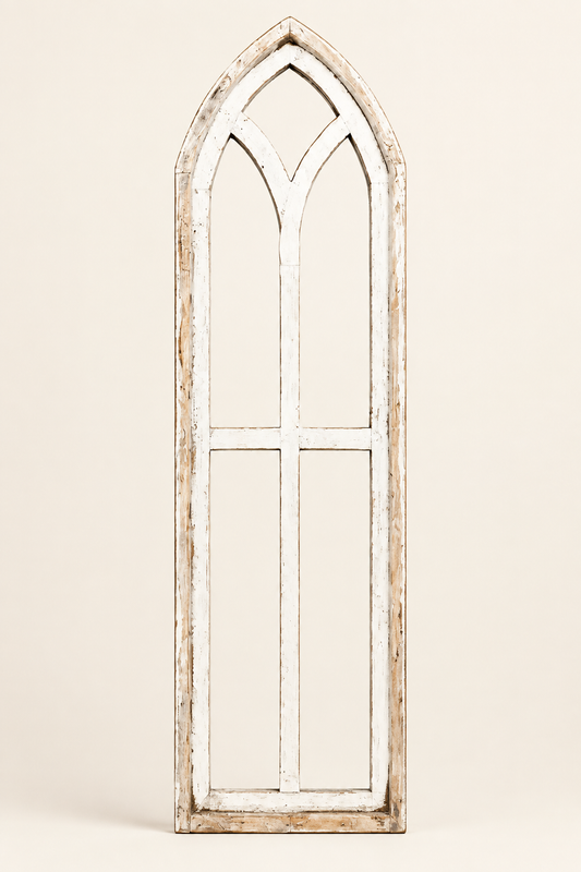 Single distressed white Pisa wooden window frame with a pointed Gothic arch and open tracery on an off-white studio background.